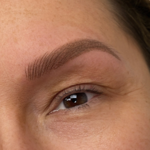 Close-up of natural looking permanent makeup eyebrows